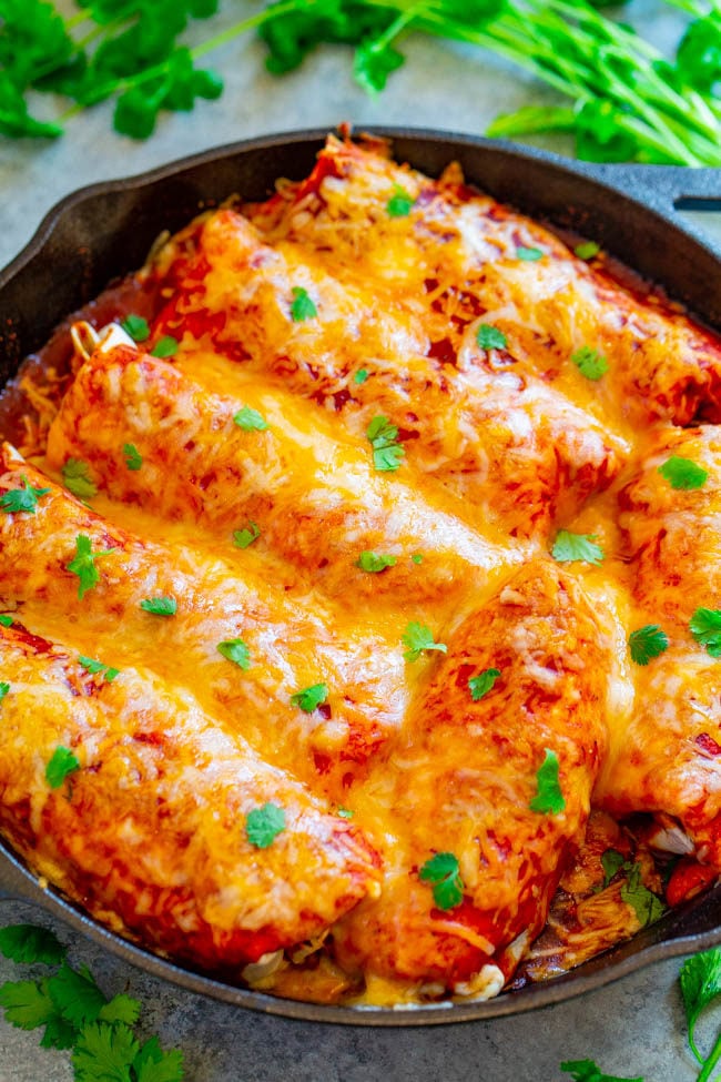 A cast iron skillet of Loaded Smothered Beef Burritos