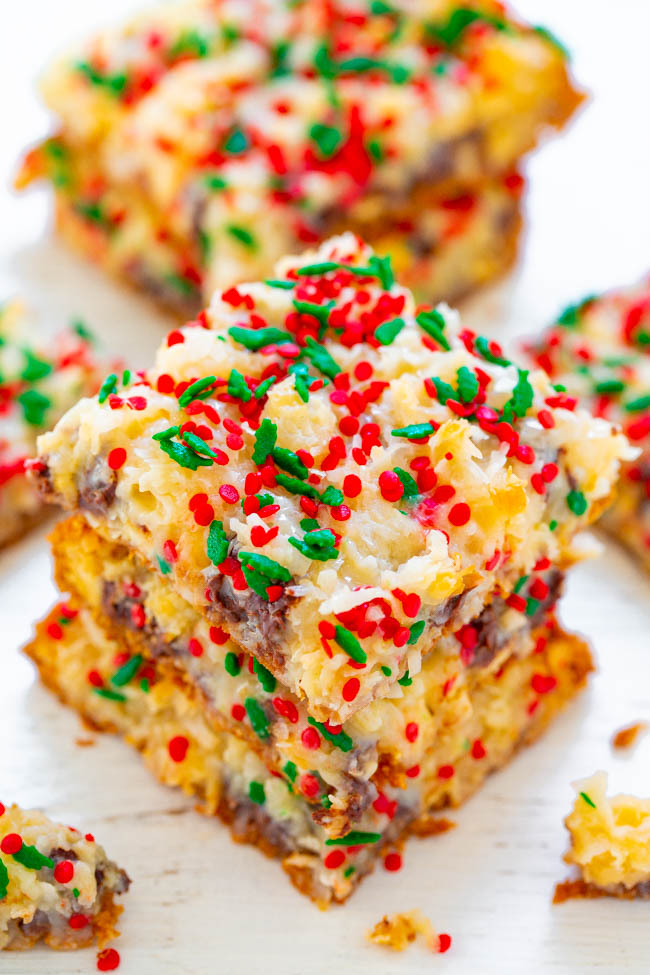 Holiday Seven Layer Bars - Soft, ultra chewy, and loaded with chocolate chips, shredded coconut, sprinkles, and more!! A FAST and EASY holiday recipe that's great for hostess gifts or cookie exchanges!!