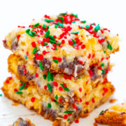 A stack of freshly baked holiday bars sprinkled with red and green festive decorations.