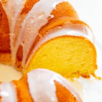 A sliced pound cake with a drizzle of white icing.