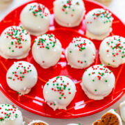 A plate of white chocolate-covered cake balls decorated with red and green sprinkles.