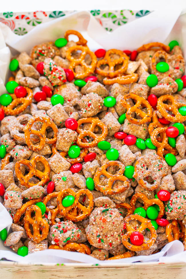 Reindeer Chow - A holiday twist on classic Muddy Buddies that's EASY, ready in 15 minutes, and perfect for hostess gifts or cookie exchanges!! Chex, chocolate, peanut butter, pretzels, M&Ms, and sprinkles make this dessert snack mix totally IRRESISTIBLE!!