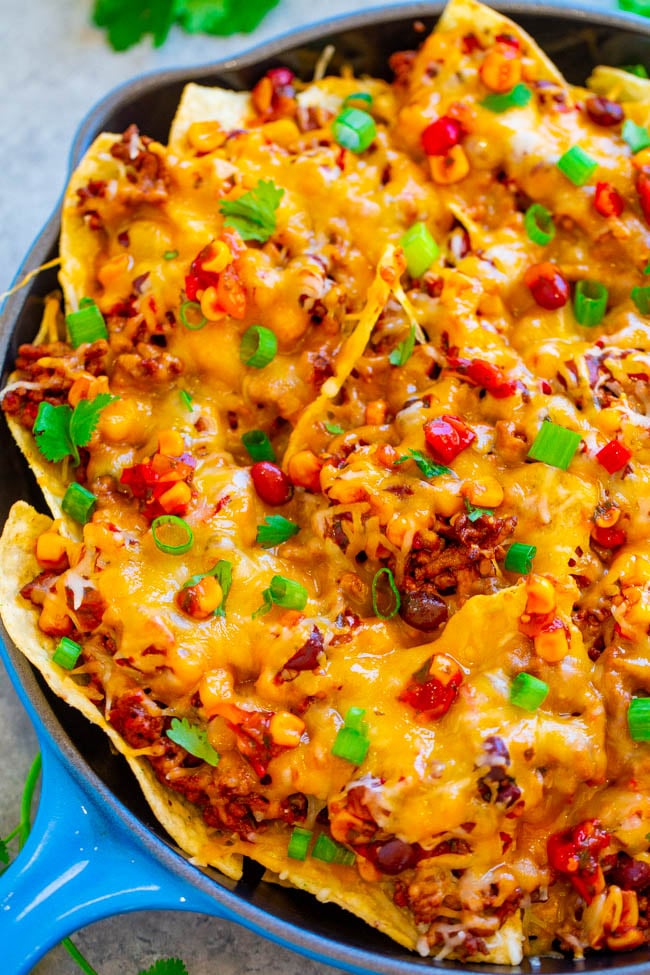 Loaded Nachos with Beef — EASY, ready in 15 minutes, and LOADED with taco-seasoned ground beef, black beans, corn, cilantro, and lots of CHEESE!! Great for parties, game days, after school snacks, or a cheat night dinner!!