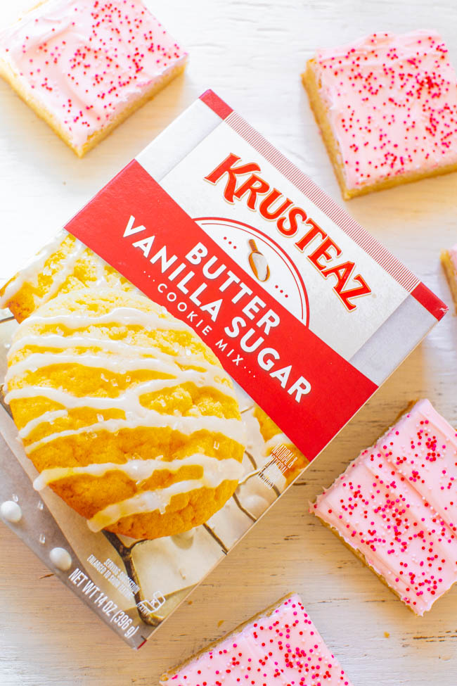 Valentine's Frosted Sugar Cookie Bars - Sugar cookie bars are so much FASTER AND EASIER than making sugar cookies!! The sprinkles and tangy cream cheese frosting help to make the bars a PERFECT Valentine's Day treat!!