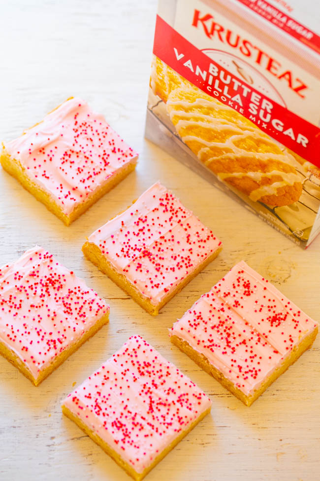 Valentine's Frosted Sugar Cookie Bars - Sugar cookie bars are so much FASTER AND EASIER than making sugar cookies!! The sprinkles and tangy cream cheese frosting help to make the bars a PERFECT Valentine's Day treat!!