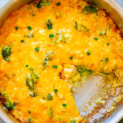 A baked broccoli and cheese casserole in a pan.