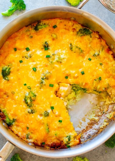 A baked broccoli and cheese casserole in a pan.