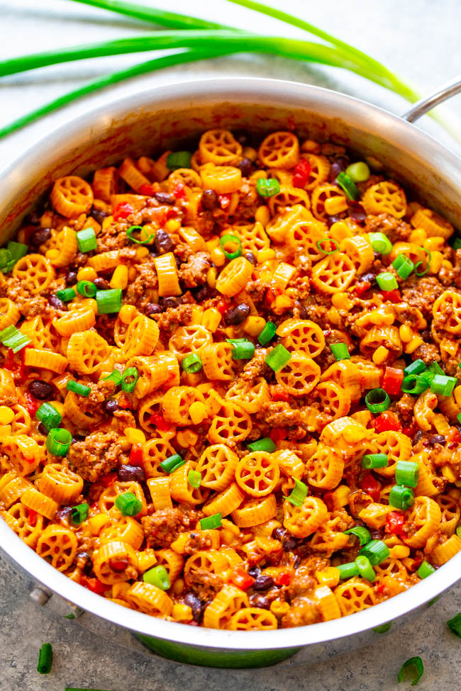 one pot cheesy taco pasta garnished with sliced green onions 