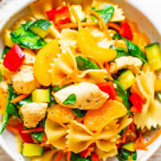 A bowl of pasta salad with chicken and mixed vegetables.