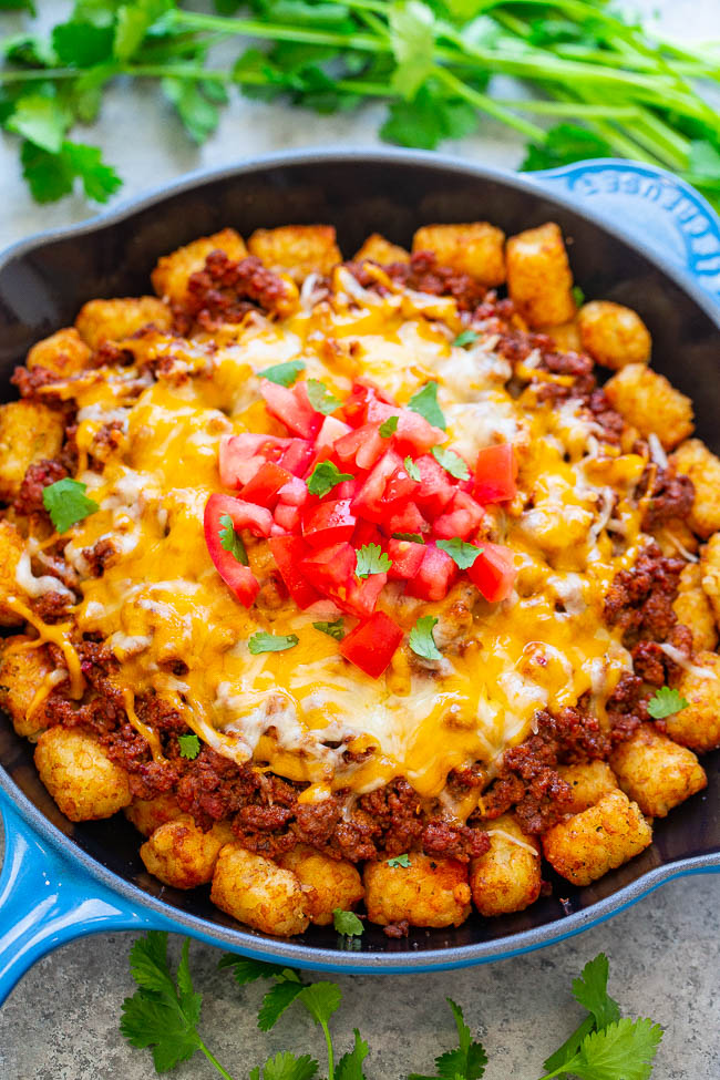 Beef Tater Tot-Chos - Crispy tater tots topped with taco-seasoned ground beef and melted cheese is a DELICIOUS and fun twist on nachos!! EASY, ready in no time, and perfect for PARTIES!!