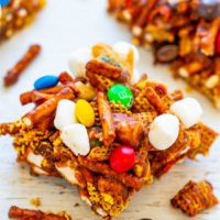 Colorful candy and marshmallow-studded snack mix on a wooden surface.