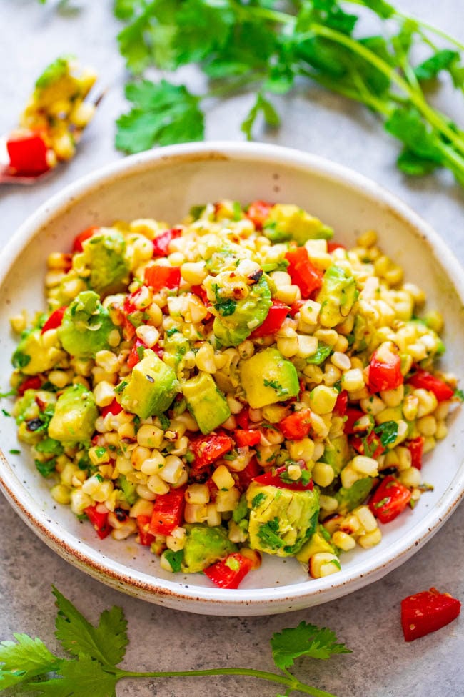 Overhead shot of Grilled Corn and Avocado Salad in a white bowl