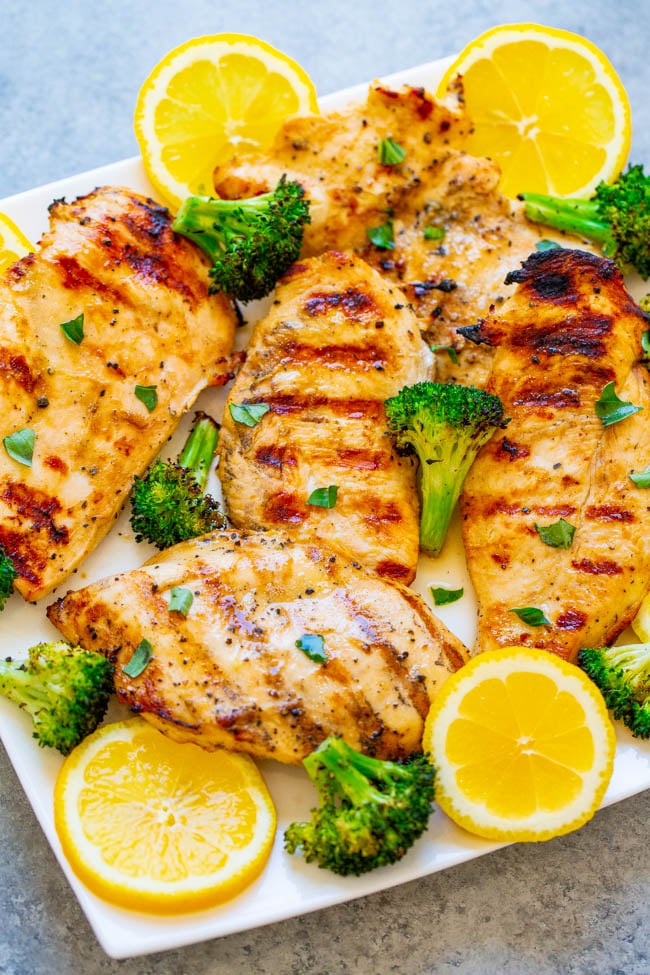 Grilled Lemon Chicken - EASY, ready in 10 minutes, and the chicken is so TENDER, juicy, and full of LEMON flavor!! With grilled broccoli on the side, this is a HEALTHY recipe perfect for swimsuit season that tastes AMAZING!!