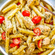 Penne pasta with chicken, cherry tomatoes, and pesto sauce.