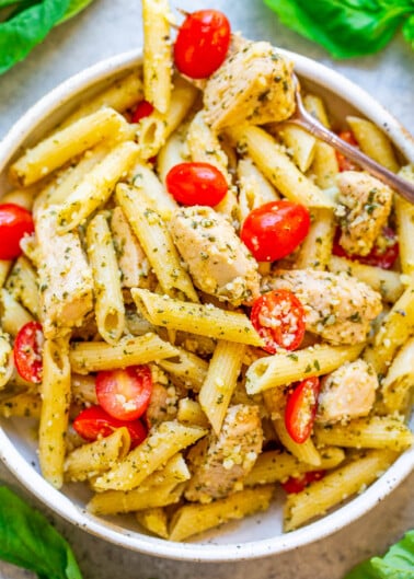 Penne pasta with chicken, cherry tomatoes, and pesto sauce.