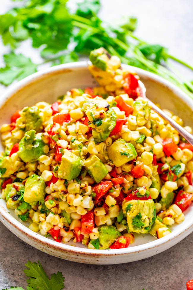 Grilled Corn and Avocado Salad - An EASY and HEALTHY salad that's ready in 10 minutes and you won't be able to stop eating it!! Juicy corn, creamy avocado, cilantro, and fresh lime juice is a FIESTA in your mouth!!