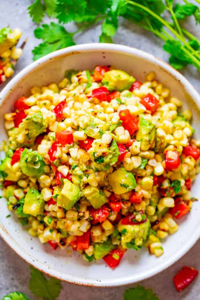 Grilled Avocado Corn Salad — An EASY and HEALTHY salad that's ready in 10 minutes and you won't be able to stop eating it!! Juicy corn, creamy avocado, cilantro, and fresh lime juice is a FIESTA in your mouth!!
