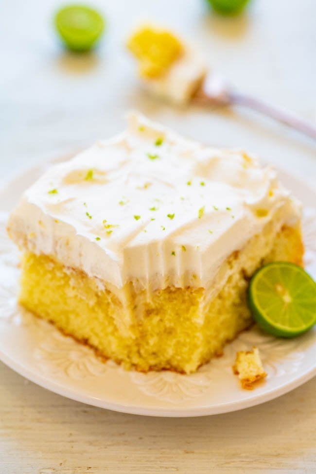 slice of key lime cake on white plate with bite missing