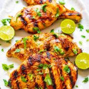 Platter with four grilled cilantro lime chicken breasts.