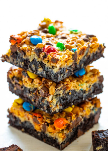 Loaded Seven Layer Brownies - The softest, fudgiest, and BEST brownies topped with coconut chocolate chips, butterscotch chips, toffee bits, M&Ms, and more!! You will never want to cheat on these INCREDIBLE brownies after trying them!!  