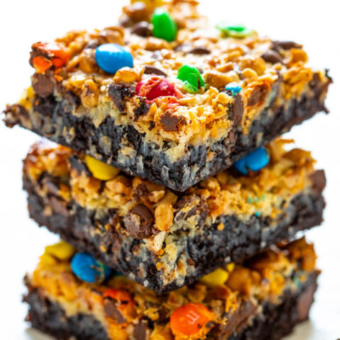 Loaded Seven Layer Brownies - The softest, fudgiest, and BEST brownies topped with coconut chocolate chips, butterscotch chips, toffee bits, M&Ms, and more!! You will never want to cheat on these INCREDIBLE brownies after trying them!!  