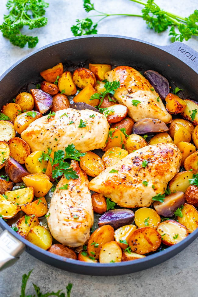 roasted chicken breast and potatoes in a skillet 