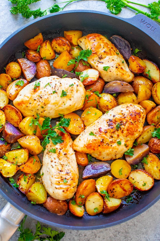 overhead view of lemon butter chicken and potatoes in a skillet 