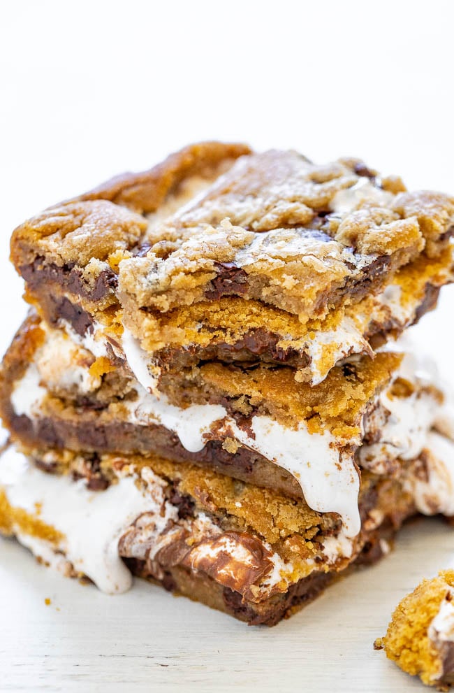 Chocolate Chip Cookie Smores Bars - Between layers of super soft chocolate chip cookie dough there's chocolate, marshmallows, and graham cracker crumbs for the most DECADENT smores ever!! So EASY and just 4 main ingredients!! 