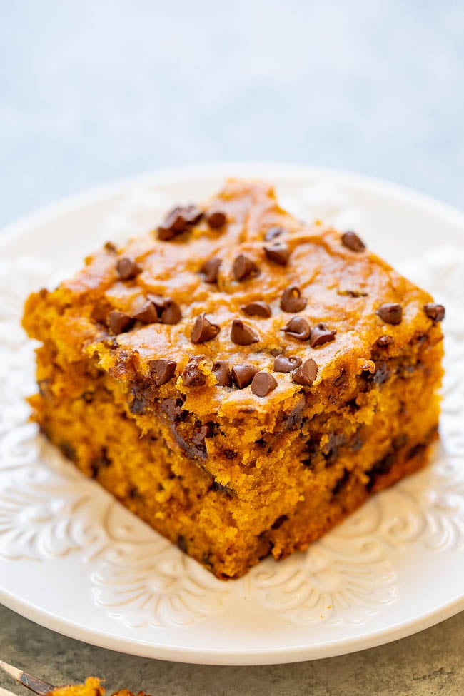 slice of pumpkin chocolate chip cake on a white plate.