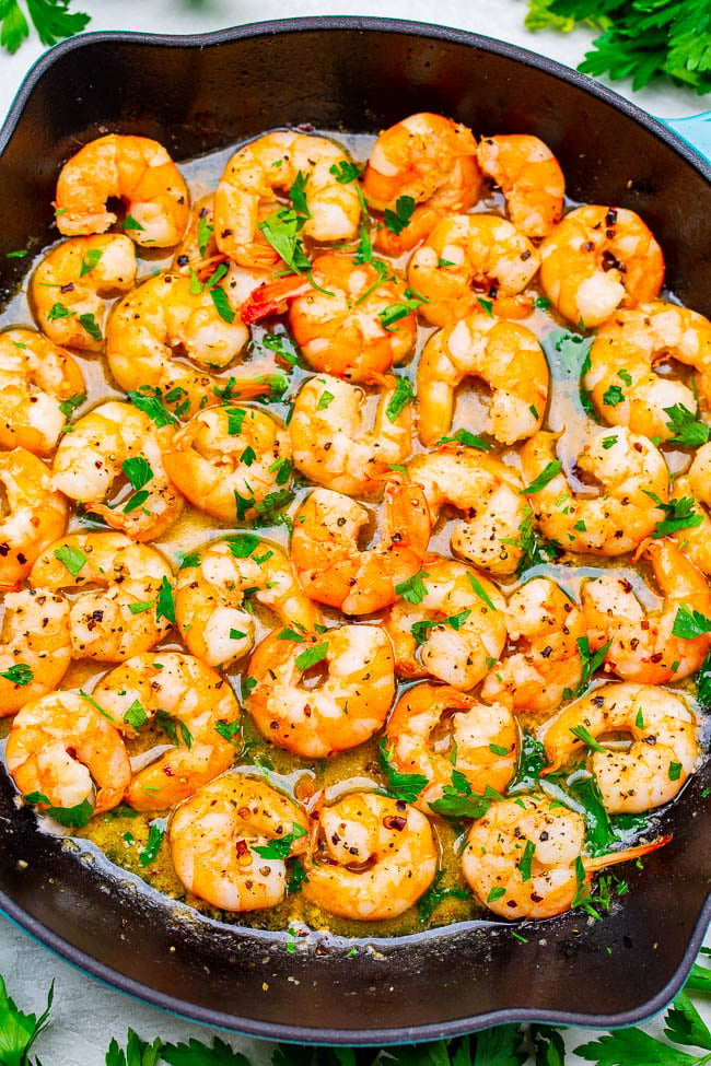 overhead view of garlic shrimp scampi in a cast iron skillet 