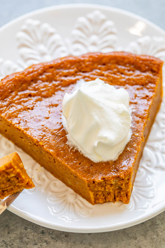 slice of pumpkin pie without crust with a bite missing on a white plate 