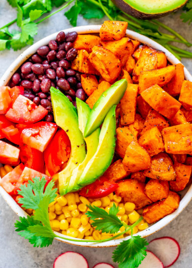 Mexican Sweet Potato and Black Bean Buddha Bowl - A HEALTHY and EASY alternative to a salad!! Loaded with Mexican-inspired ingredients and topped with a light lime-cumin vinaigrette! Ready in 20 minutes and perfect for MEAL PREPPING!!