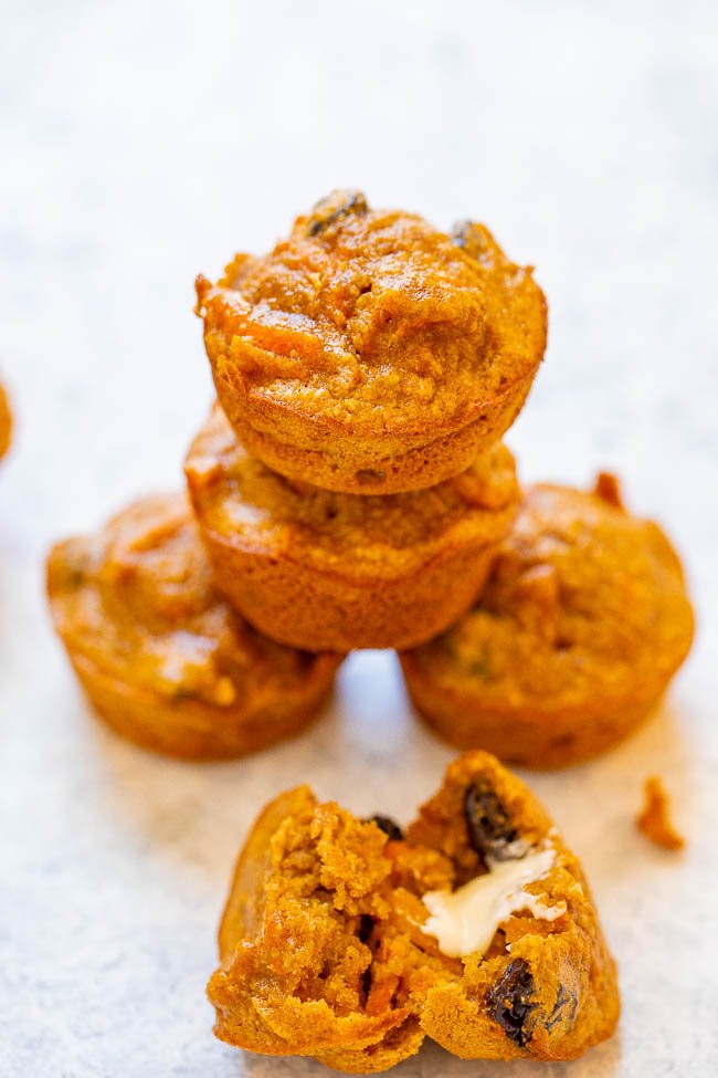 stack of four gluten free morning glory muffins with a halved muffin in the foreground 