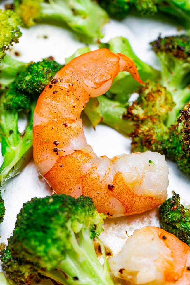 close up of roasted shrimp and broccoli on a sheet pan 