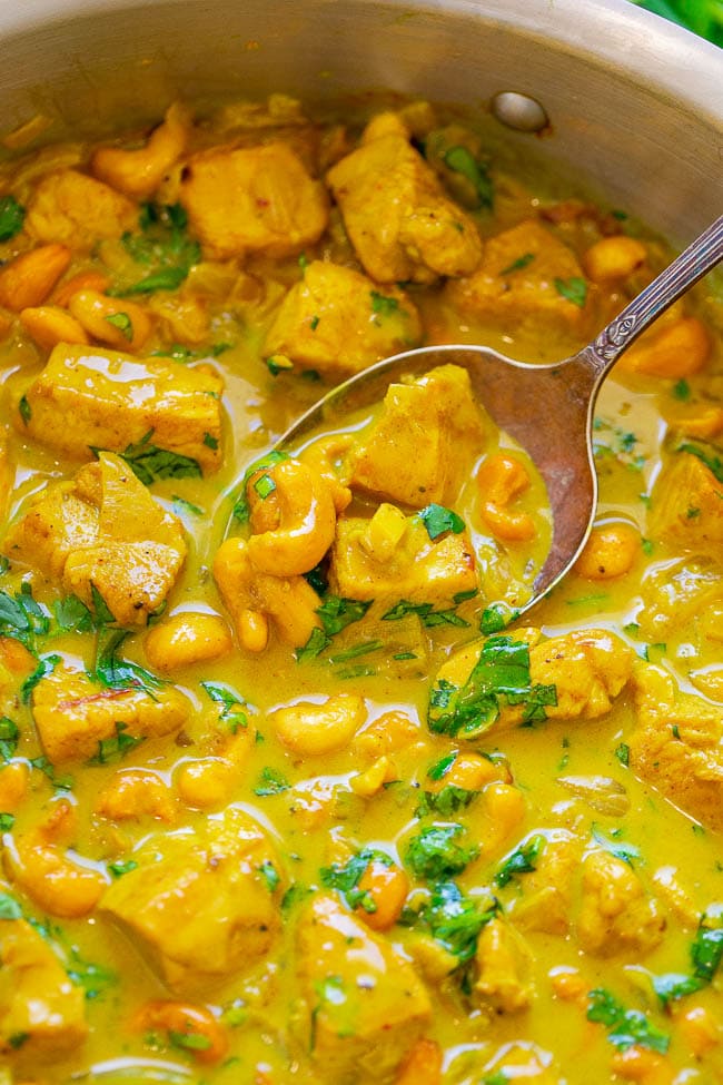 Yellow Chicken Coconut Curry (Chicken Korma) in pot with spoon