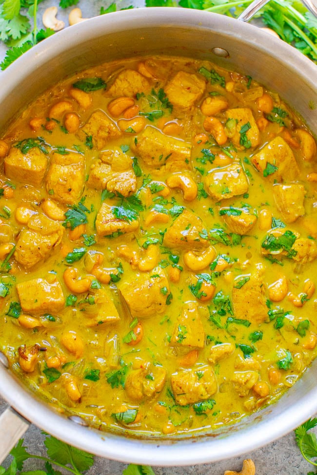 overhead view of chicken korma in a metal skillet 