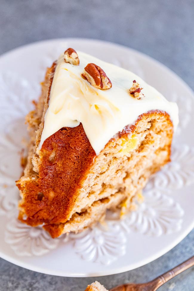 Hummingbird Cake - A super SOFT and moist cake with bananas, pineapple, coconut, cream cheese frosting, and pecans!! Makes a huge cake that'll feed a crowd! If you like banana bread, you will LOVE this cake! Put this EASY retro gem on your baking list!!