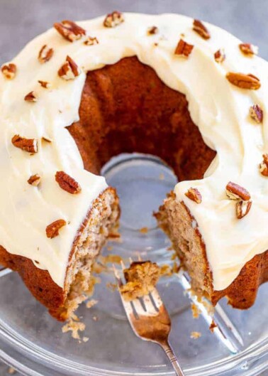 Hummingbird Cake - A super SOFT and moist cake with bananas, pineapple, coconut, cream cheese frosting, and pecans!! Makes a huge cake that'll feed a crowd! If you like banana bread, you will LOVE this cake! Put this EASY retro gem on your baking list!!