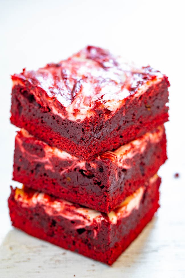 Red Velvet Cheesecake Brownies - Rich, decadent, red velvet brownies topped with tangy cream cheese swirls!! PERFECT for Valentine's Day, the Christmas season, or anytime you're craving red velvet! EASIER than you think to make!!