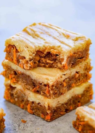 Carrot Cake Cream Cheese Blondies - Dense, chewy, super moist bars that taste like carrot cake with a cream cheese topping that's baked right in so you don't need to worry about frosting them!! So much EASIER than making carrot cake but with similar flavors you will LOVE!!