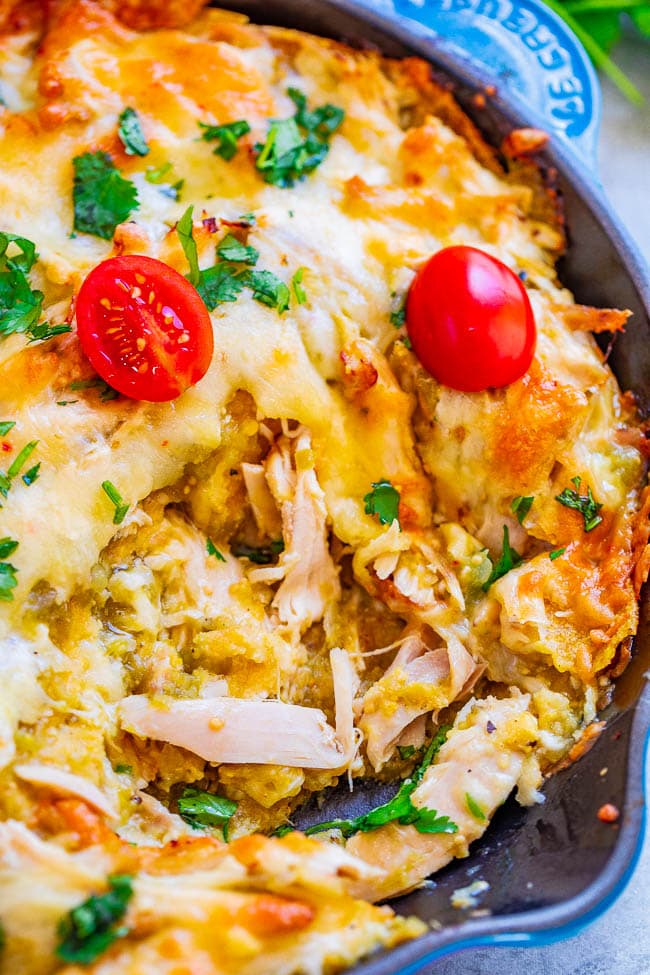 Salsa Verde Chicken Chilaquiles — An EASY comfort food recipe with just FOUR main ingredients and ready in 30 minutes!! Green chilaquiles are made with layers of corn tostadas and juicy chicken smothered in salsa verde and melted pepper Jack cheese!