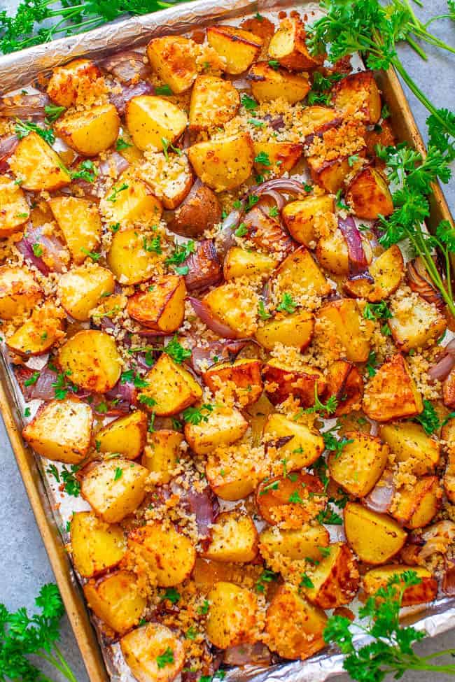 Crispy Parmesan Ranch Roasted Potatoes - The BEST roasted potatoes you'll ever eat!! Tender potatoes seasoned with ranch mix and topped with a CRISPY Parmesan breadcrumb topping! So DELICIOUS you don't even need a main course!!