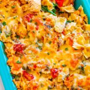 Cheesy Spinach and Artichoke Chicken Pasta in a blue baking dish.