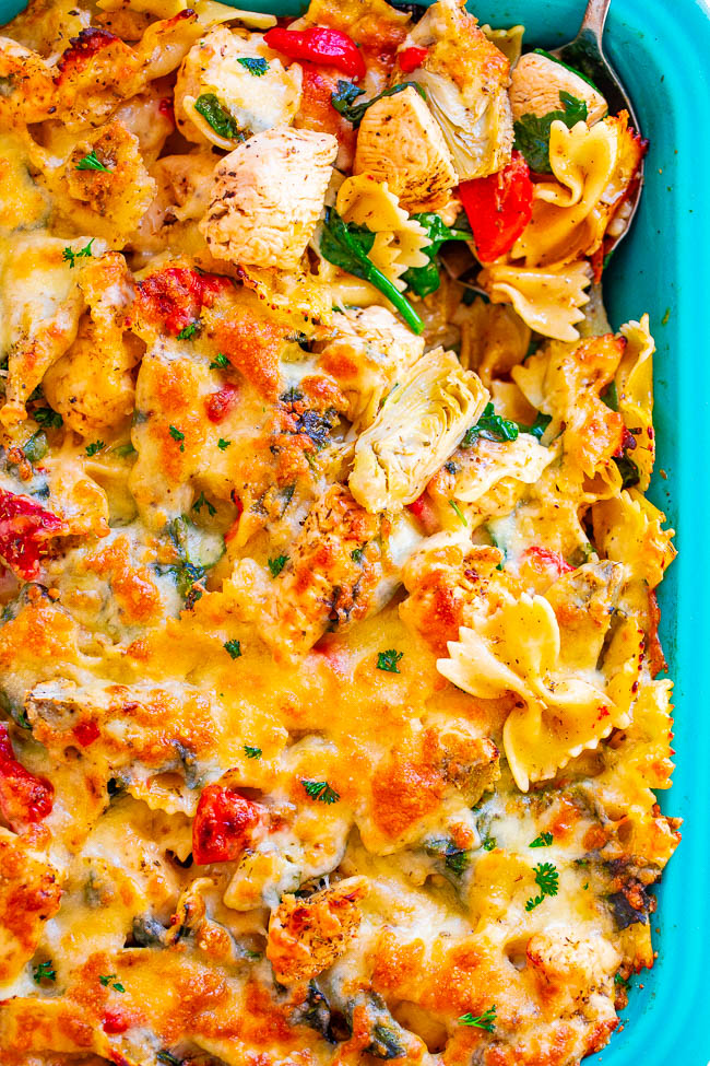 Cheesy Chicken Artichoke Pasta Bake — Imagine spinach and artichoke-flavored PASTA spiked with juicy chicken, red peppers, and TWO types of melted cheese!! A family favorite big-batch COMFORT FOOD PANTRY RECIPE that's great for meal prepping!!