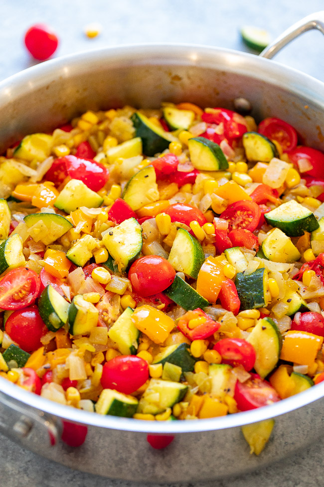 Skillet Zucchini, Corn, and Peppers (Calabacitas) - An EASY Mexican-inspired recipe ready in 15 minutes with zucchini, corn, bell peppers, tomatoes, and green chiles!! HEALTHY, vegan, and naturally gluten-free! When there's an abundance of summer produce, this recipe is PERFECT!! 