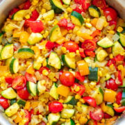 Skillet Zucchini, Corn, and Peppers (Calabacitas) - An EASY Mexican-inspired recipe ready in 15 minutes with zucchini, corn, bell peppers, tomatoes, and green chiles!! HEALTHY, vegan, and naturally gluten-free! When there's an abundance of summer produce, this recipe is PERFECT!! 