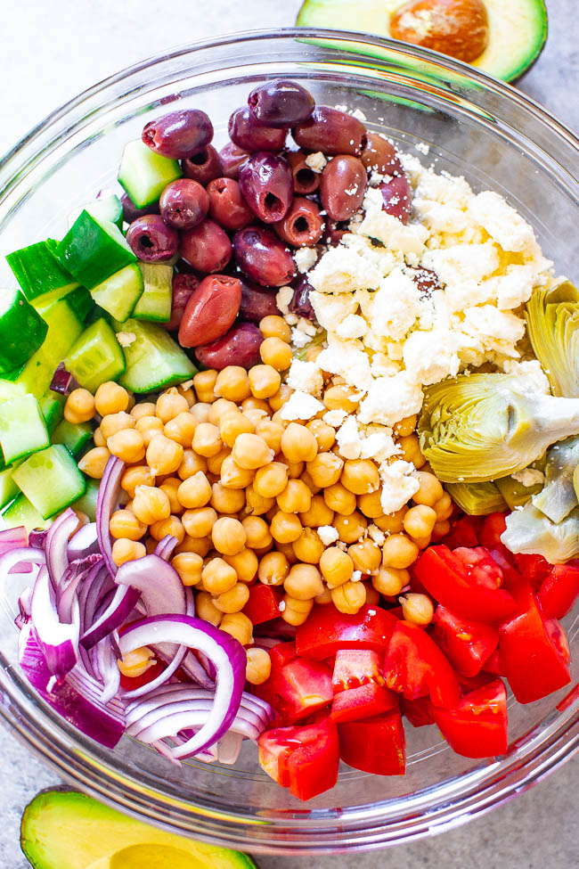 overhead view of ingredients for Loaded Greek Salad in glass bowl