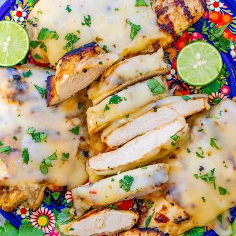 Grilled Salsa Verde Pepper Jack Chicken - The EASIEST salsa verde marinade keeps this chicken so juicy and tender!! Melted pepper Jack cheese on top takes an already awesome piece of chicken and makes it that much BETTER!!