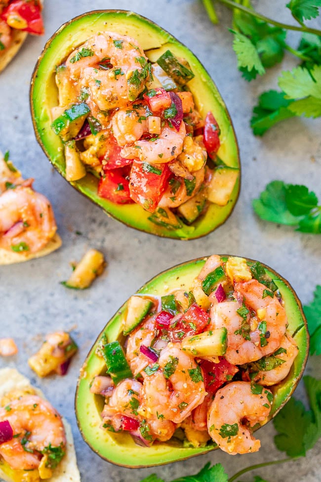 Shrimp Stuffed Avocados - If you like ceviche, you're going to LOVE these EASY avocados stuffed with a mixture of shrimp, tomatoes, cucumber, red onions, and more - plus some hot sauce for a touch of heat!! There's a time-saving shortcut so these are ready in 15 minutes with no fuss!!