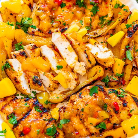Grilled Mango Pineapple Chicken - EASY, ready in 10 minutes, and the flavor of the juicy chicken makes you feel like you're on a TROPICAL island!! Grilled peppers on the side makes for the PERFECT summer meal that's HEALTHY and DELICIOUS!!